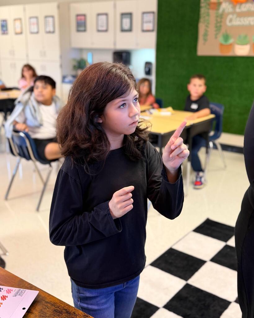girl visibly thinking at the board