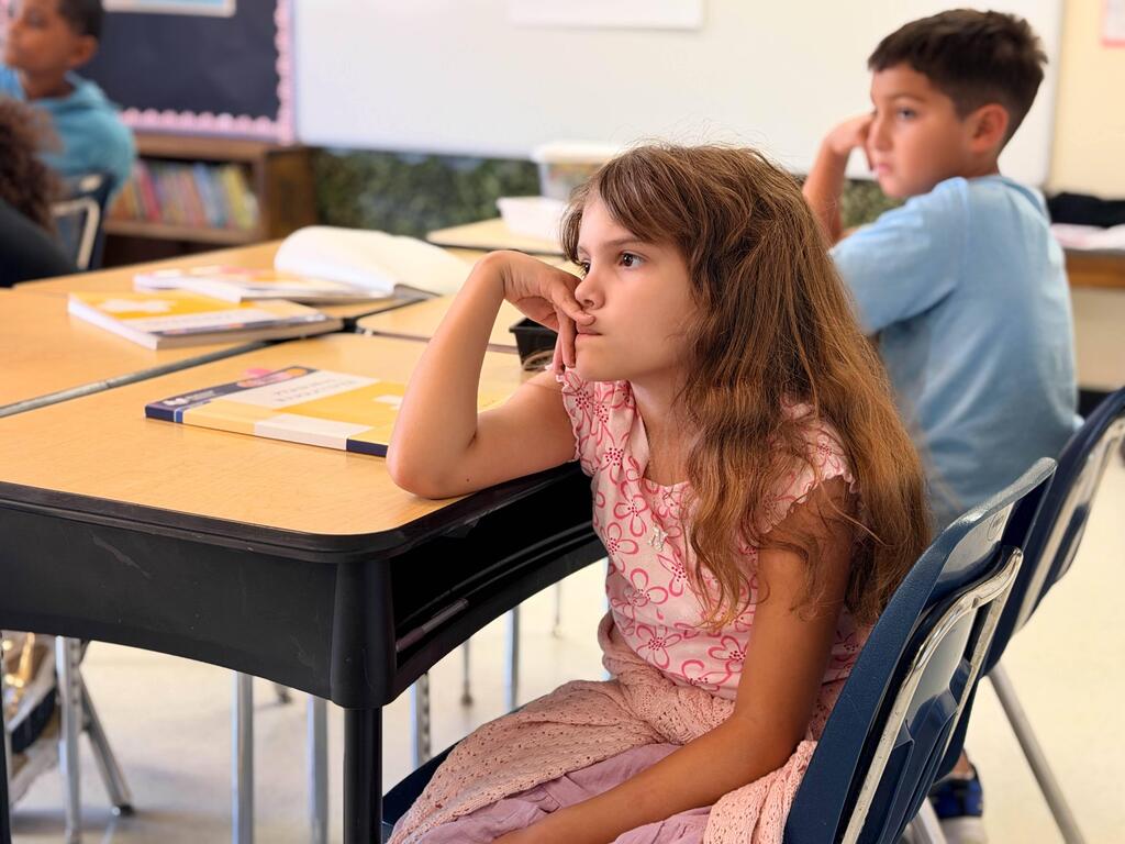 Girl in deep thought- boy in background also paying attention