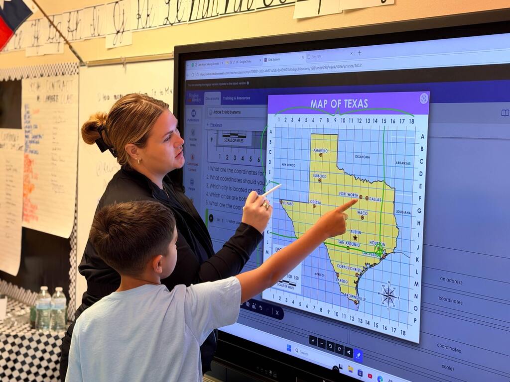 A boy points out the city in the coordinates