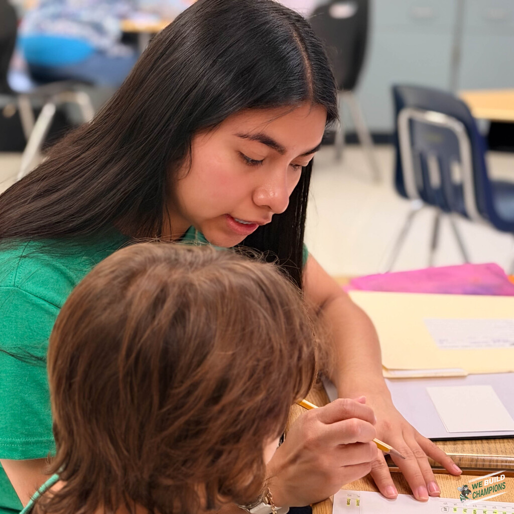 Young woman working with student