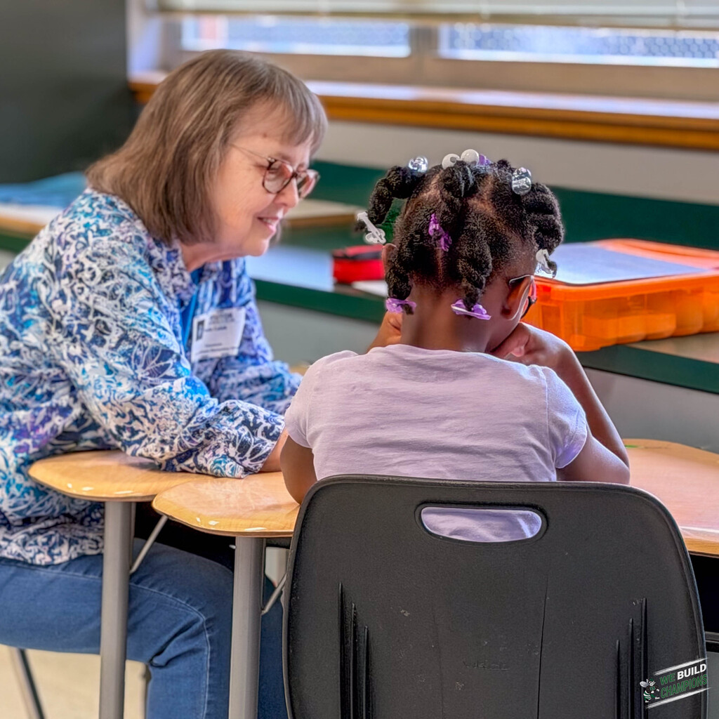 Lady smiling while looking on the girl she is working with