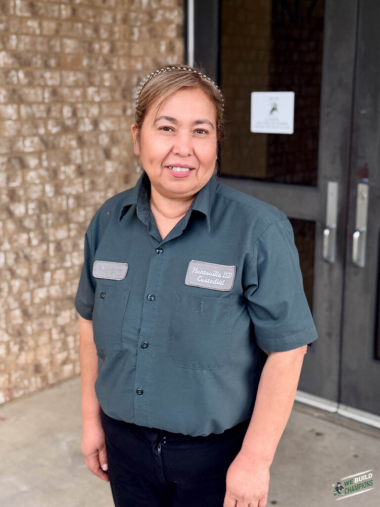 custodian posing outside of the side of the high school
