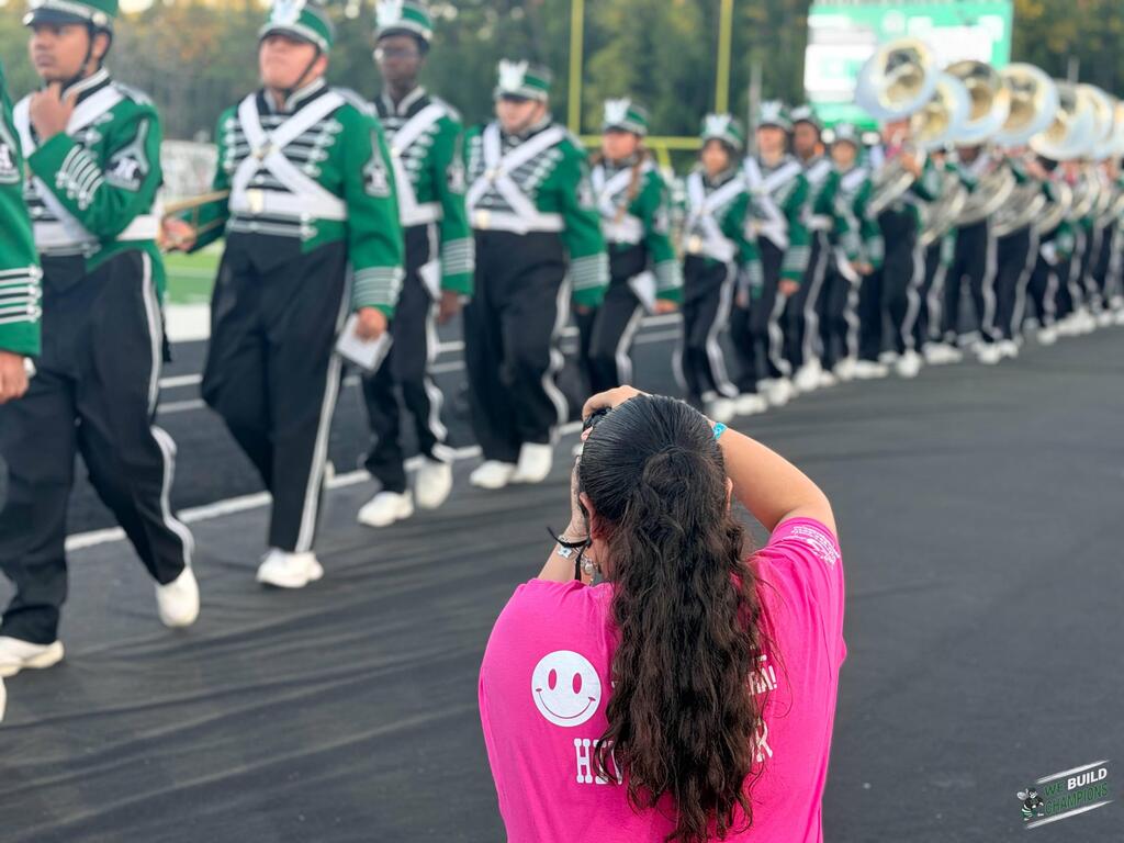 student journalist taking photo of band
