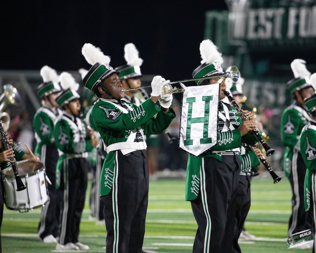 Band performing special song with satin sash hanging from horn