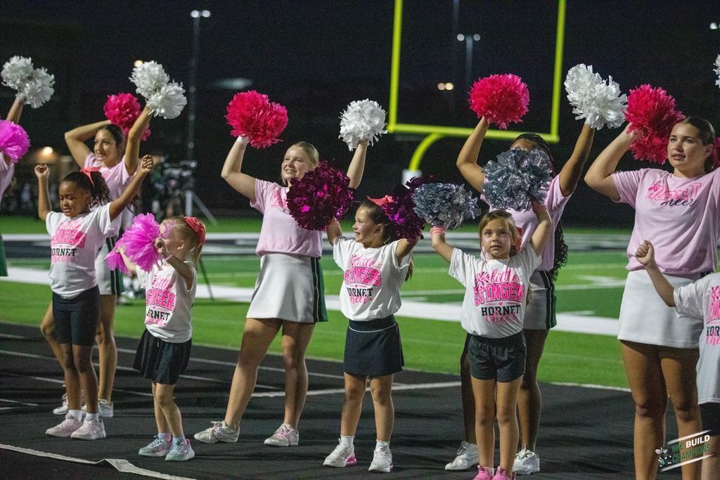 little cheer leaders perform with HHS Cheer team