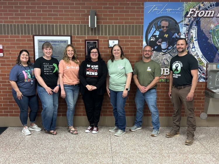 6 staff members wearing mental health shirts
