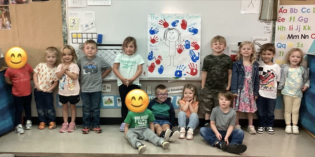 Students pictured with their classroom social contract.