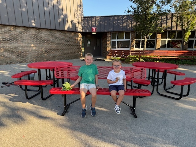 Students sitting on playground furniture