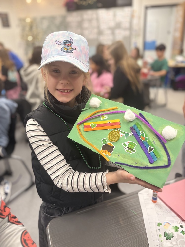 Student holding a Leprechaun trap made with the JOI club