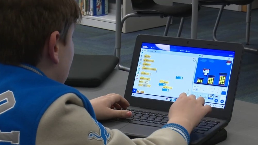 Student on laptop learning to code