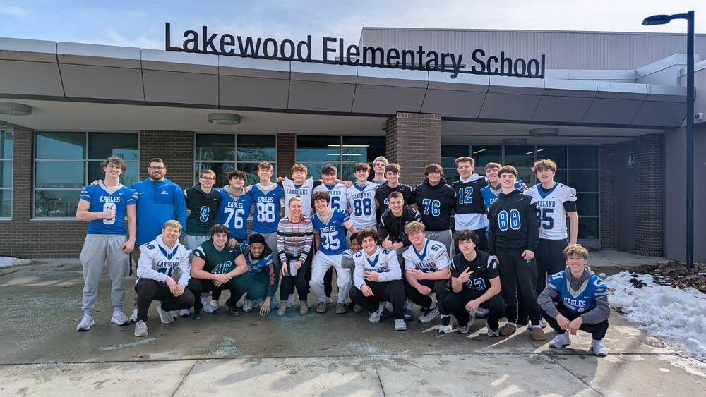 LHS football players reading to lakewood students