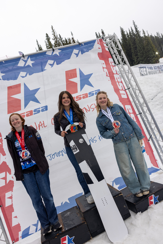 Image of kate hanneman on medal stand after winning national championship