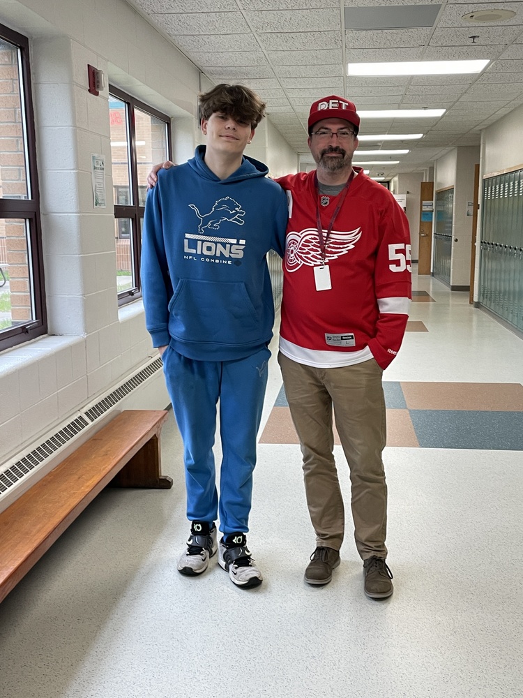 Mr. Dowker in team gear with a student
