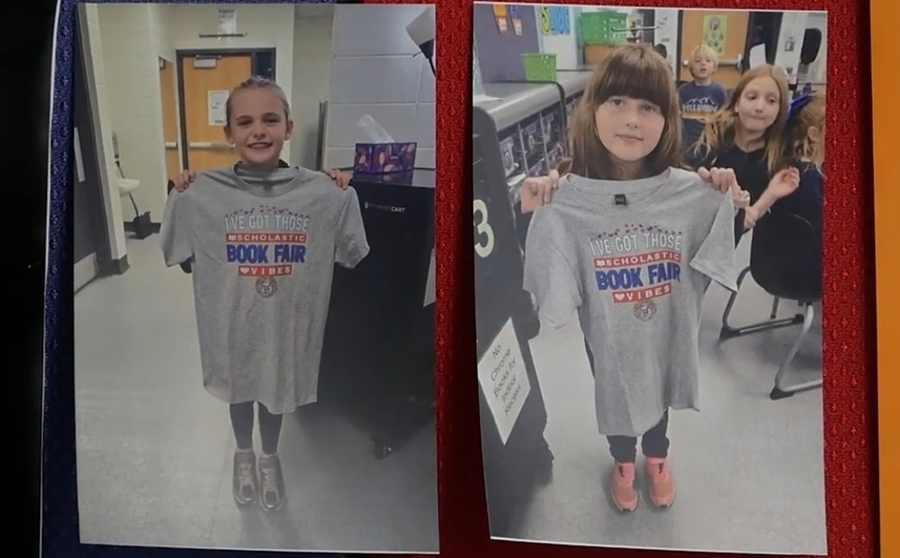 two separate photos showing young school girls holding up tshirts they designed that read "book fair"