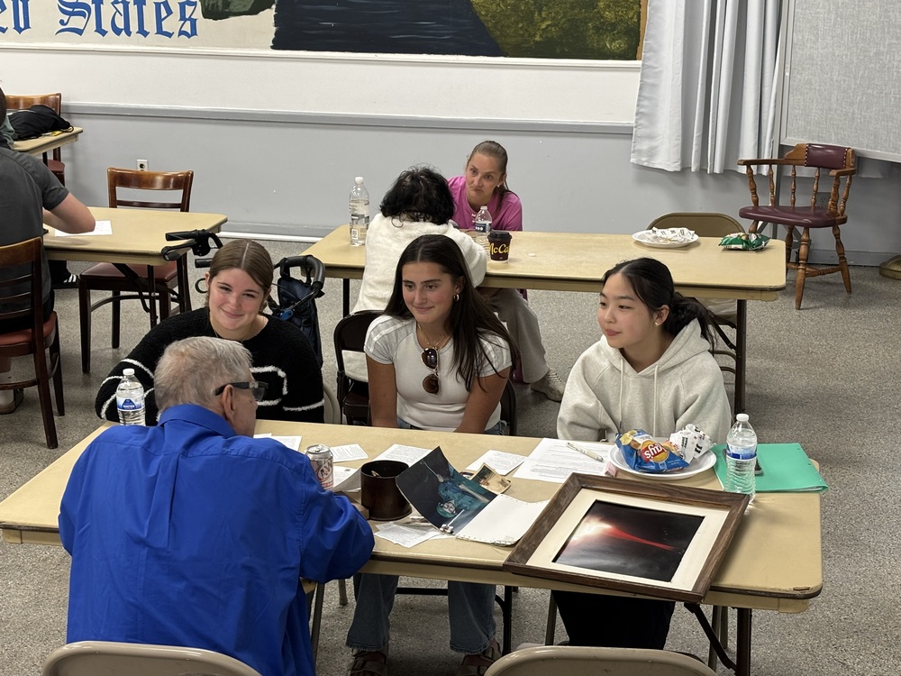 Students interviewing a local veteran