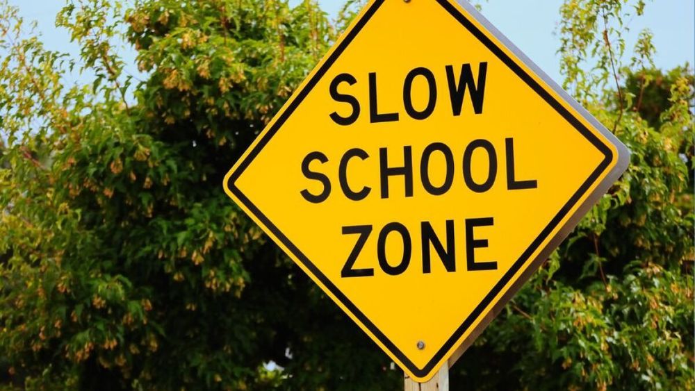slow school zone sign