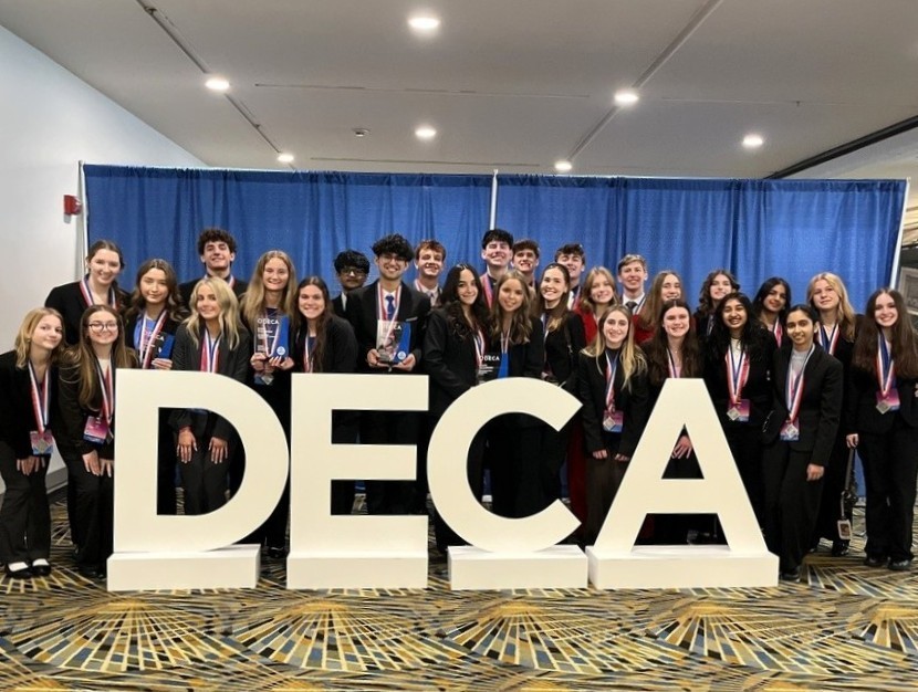 Several HVS students in front of DCA sign at conference in Detroit