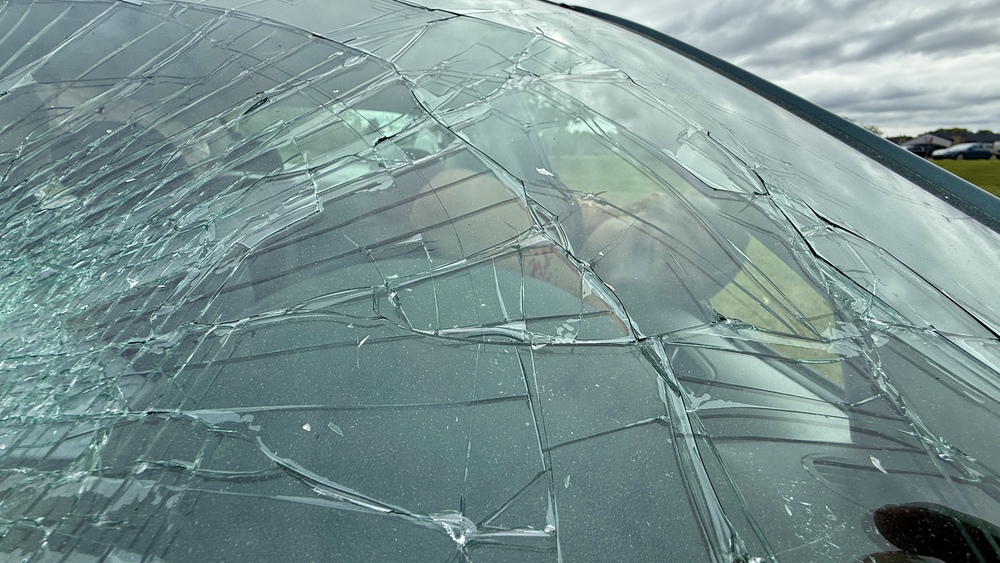 Cracked windshield and student acting unconscious during a simulation of a car crash