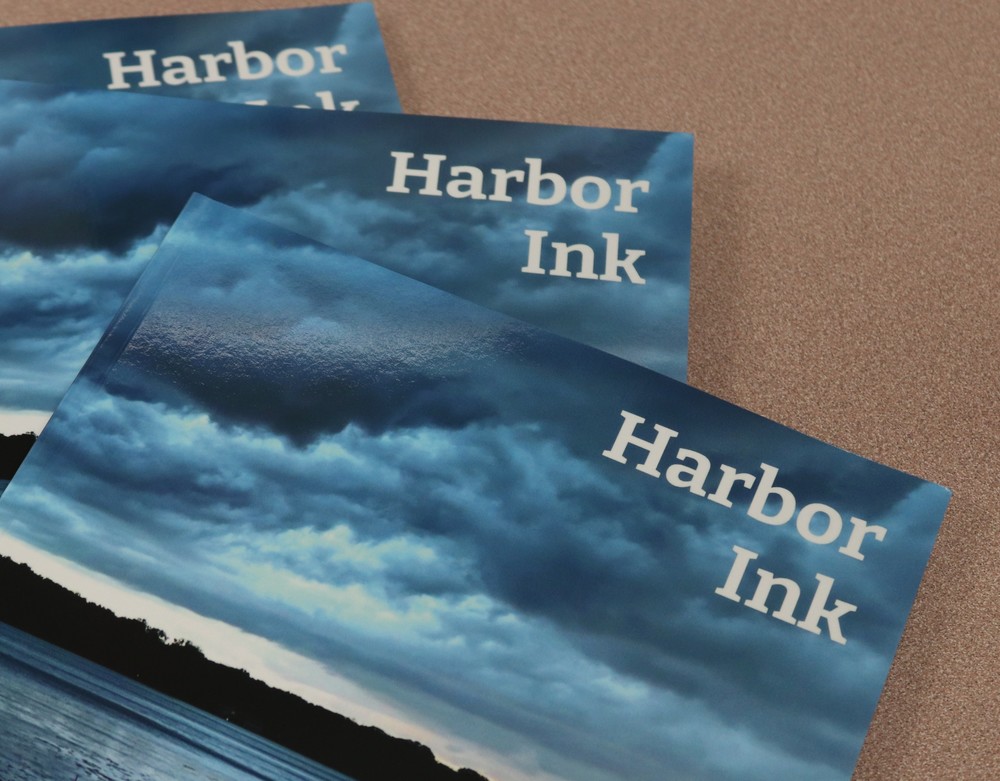 Image of 'Harbor Ink' magazine cove which shows blue-is clouds over a lake