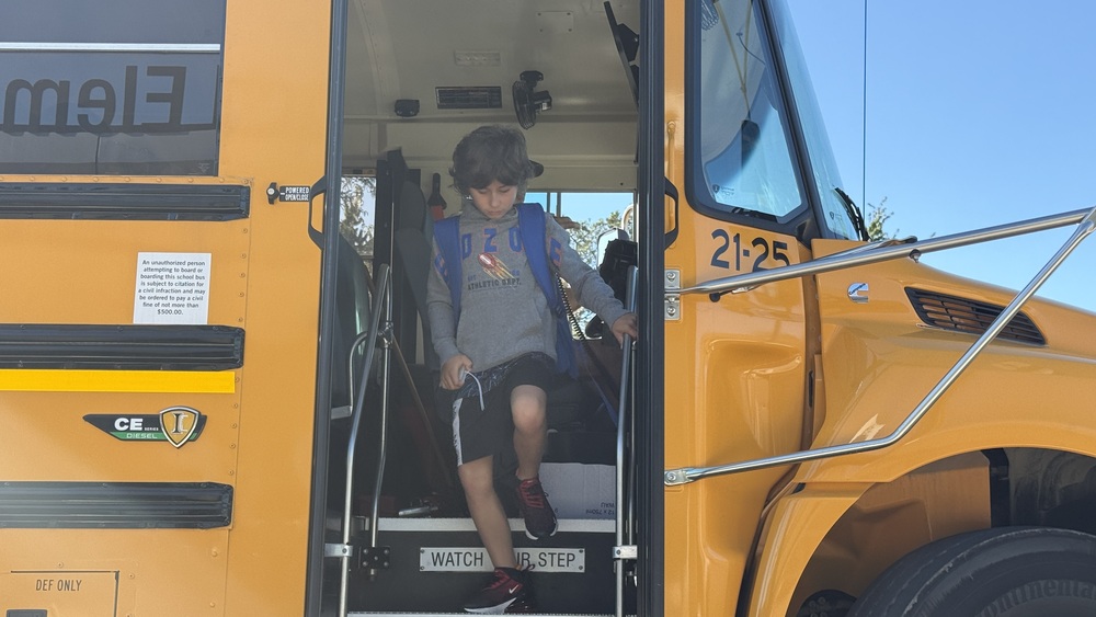 photo of kid walking off school bus