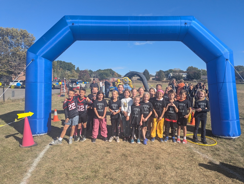 Students posing at entrance to fun run track