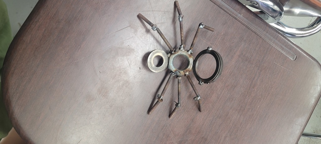 Students weld scrap metal into small sculptures in 6th hour.