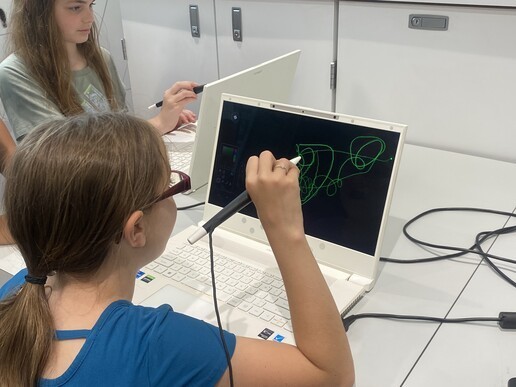 Student using a computer with a stylus 