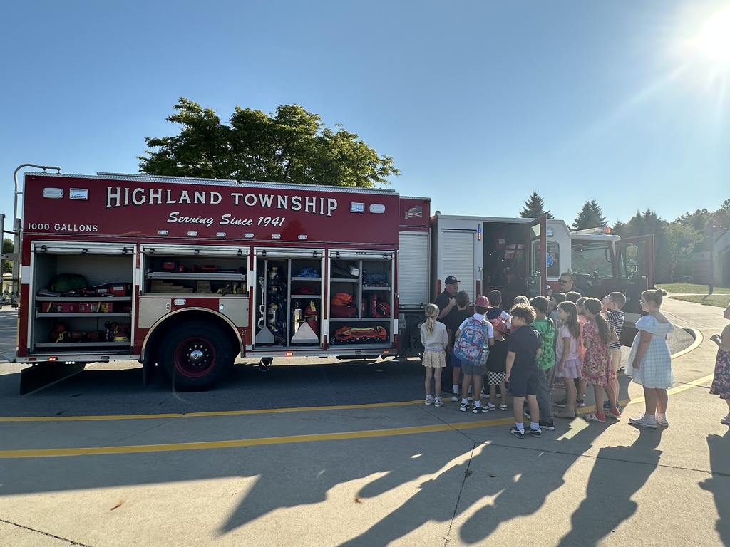 Students look inside a firetruck