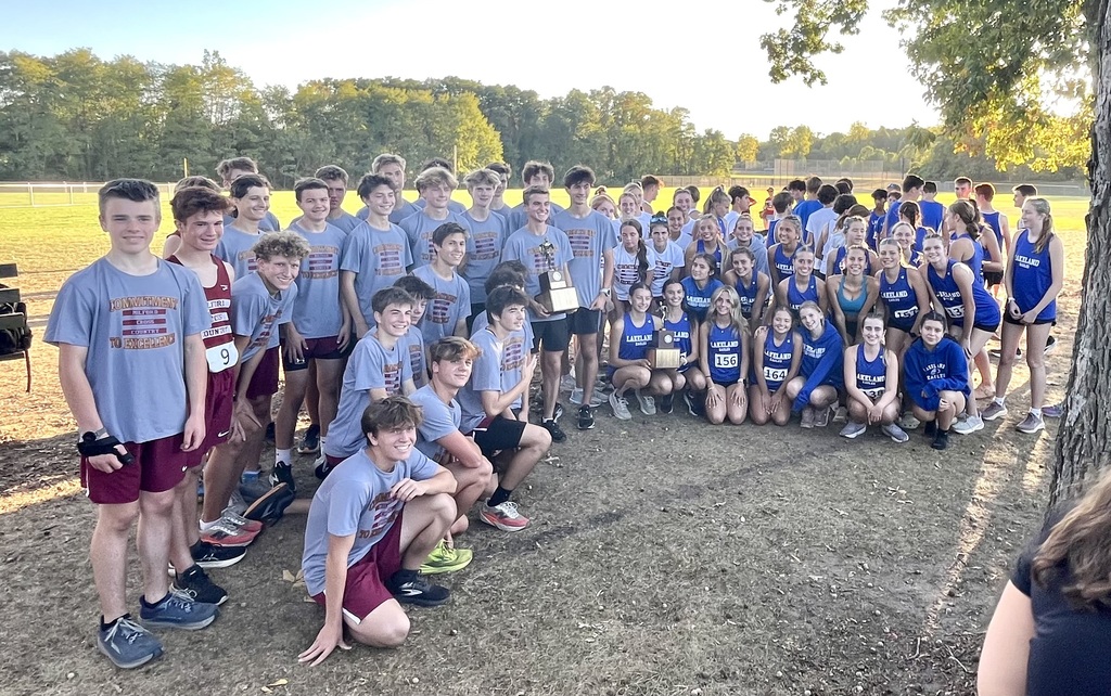 Cross country teams from Milford & Lakeland pose with the Rotary Cup