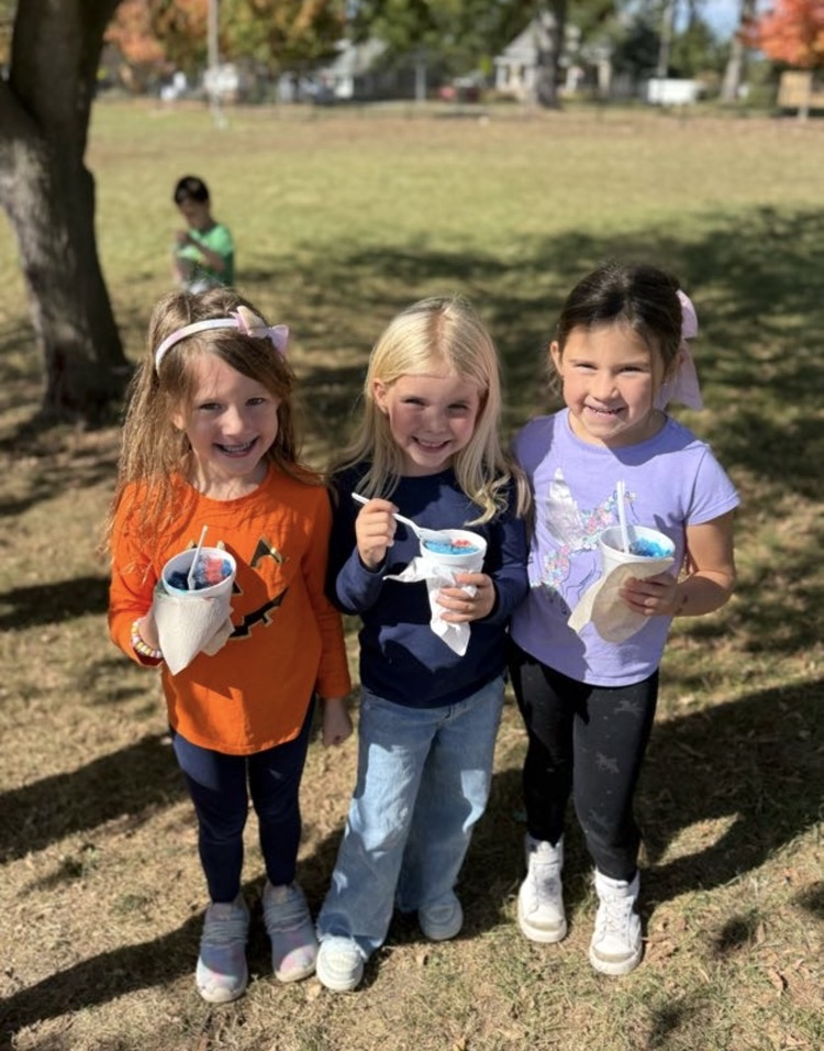 students enjoying snowy owl shaved ice reward from hitting our fun run goal!