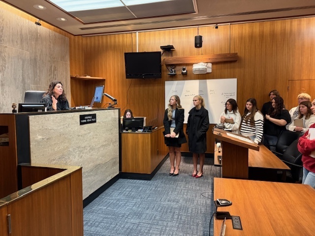 A judge talking to a group of students.
