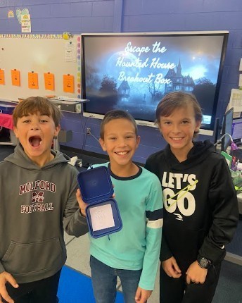 Students worked together to get the prizes out of the Breakout EDU boxes.