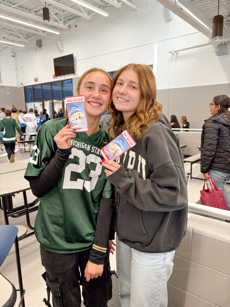 Girls holding DQ gift certificates