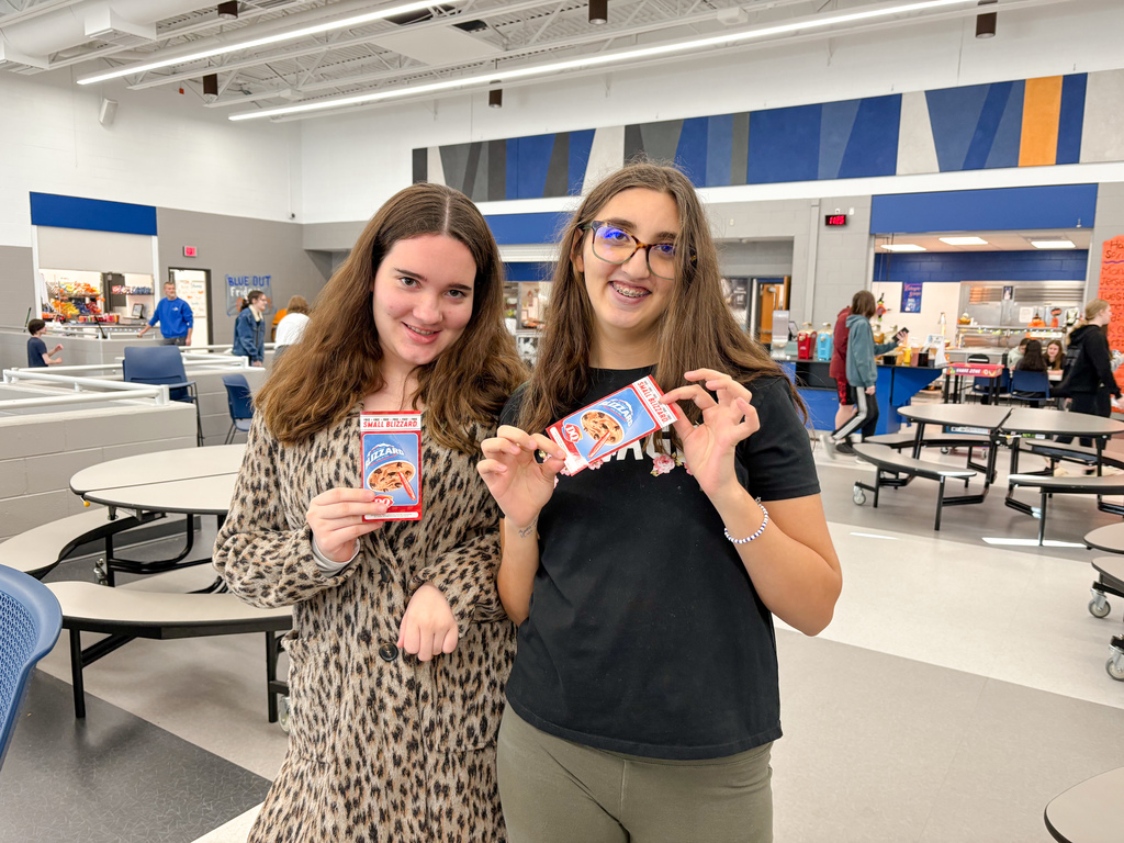 Girls holding DQ gift certificates