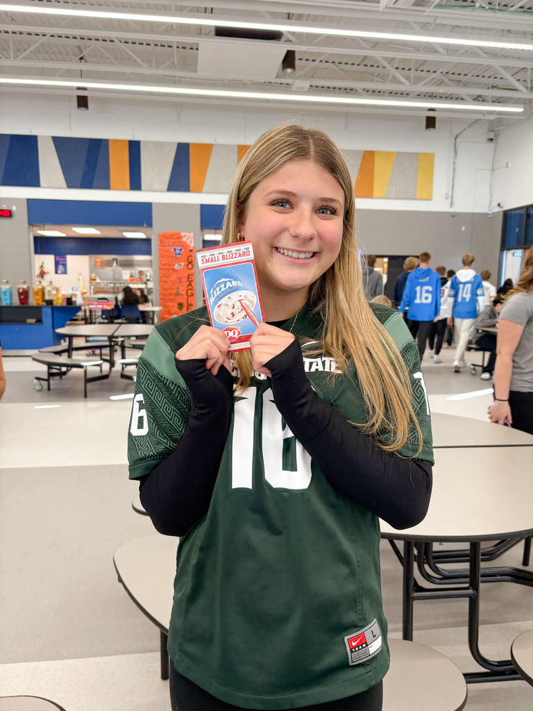 Girls holding DQ gift certificates