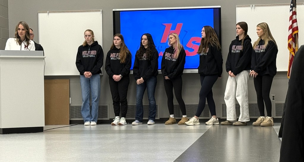 Picture of several members from the Milford Girls Volleyball Team at school board meeting