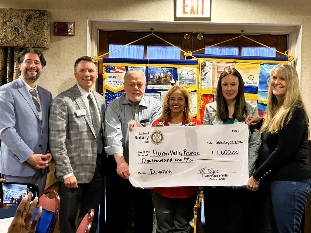 Picture of members of Milford Rotary presenting a check for $1,000 to the Huron valley Promise