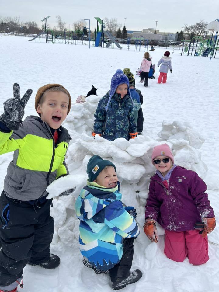 students playing in the snow