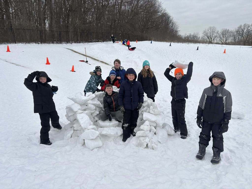 students playing in the snow