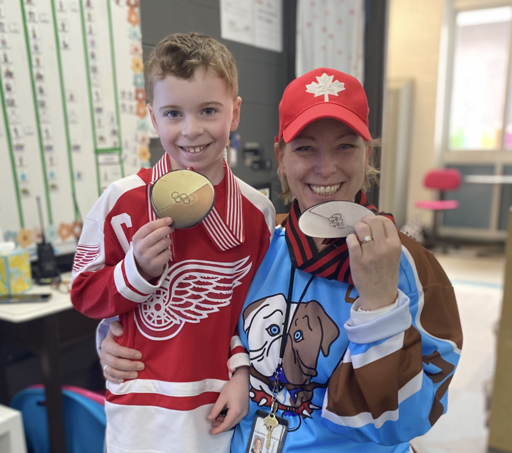 staff and student with silver and gold medals