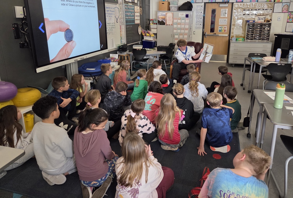 LHS football players reading to lakewood students