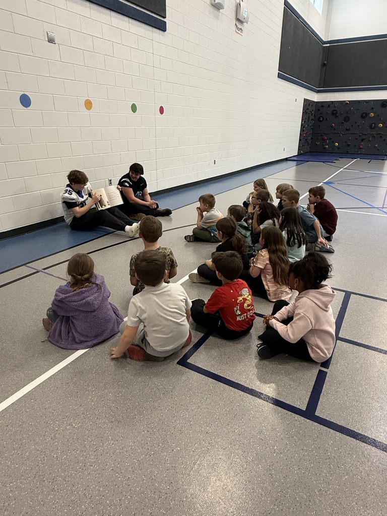 LHS football players reading to lakewood students