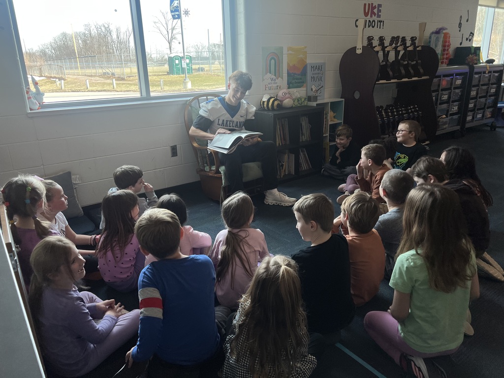 LHS football players reading to lakewood students