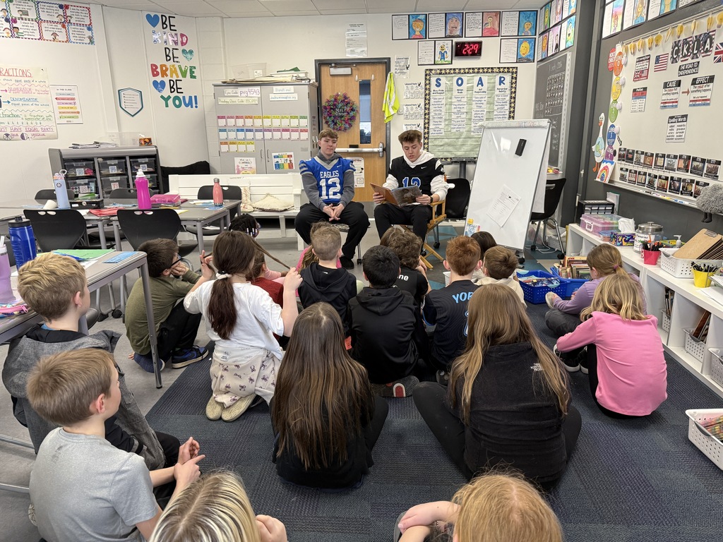 LHS football players reading to lakewood students