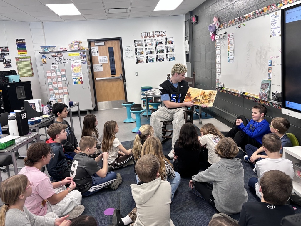 LHS football players reading to lakewood students
