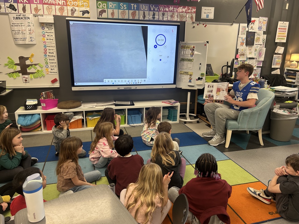 LHS football players reading to lakewood students