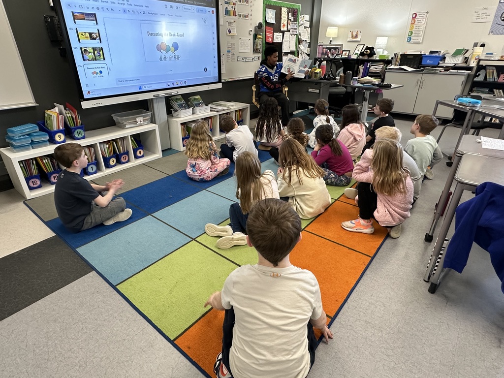 LHS football players reading to lakewood students