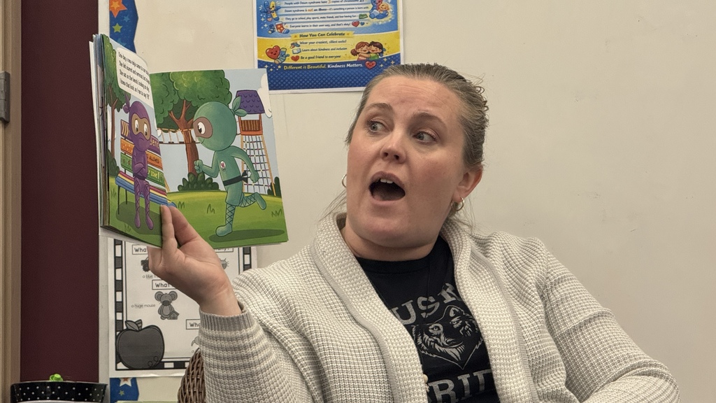teacher reading a children's  book 