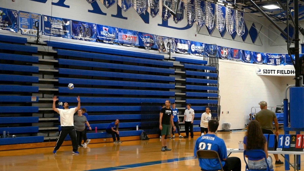 Images of LHS staff playing LHS students in volleyball