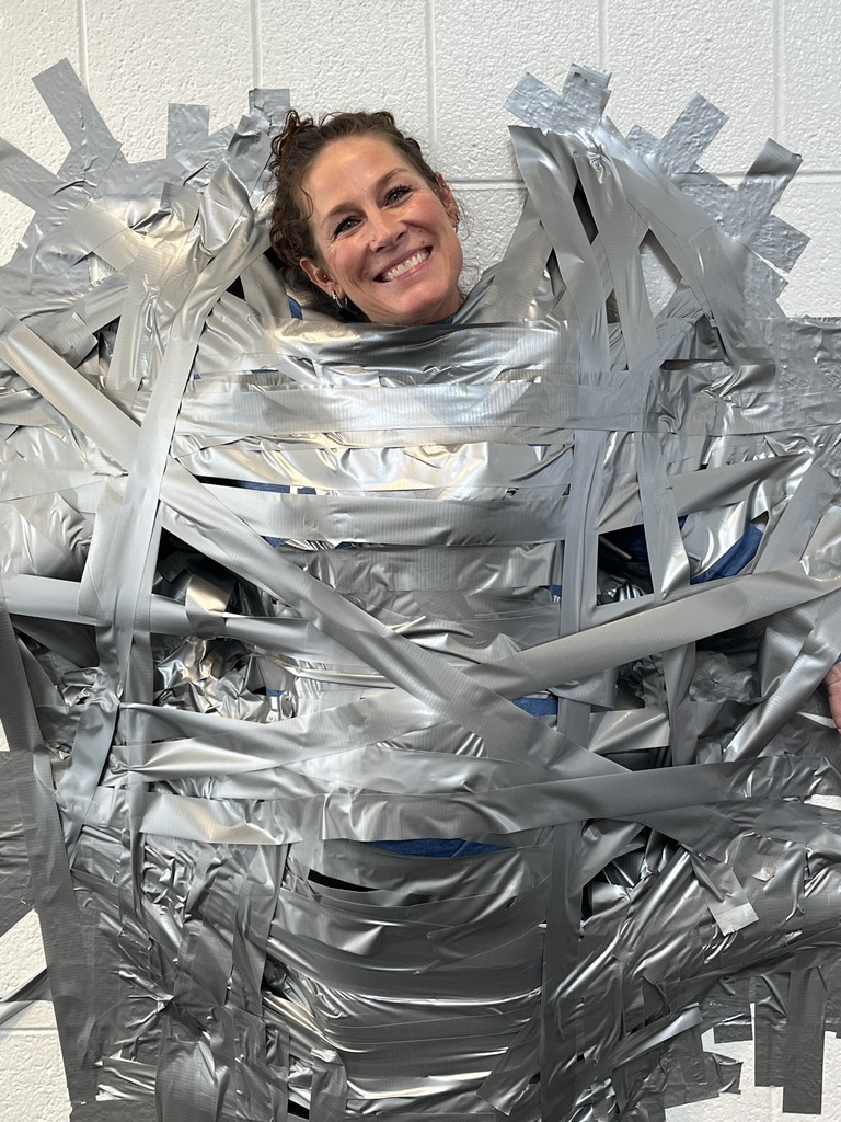 Hollowell taped to wall smiling